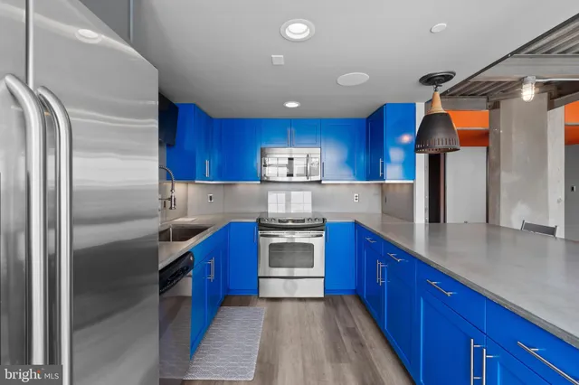 a kitchen with stainless steel appliances wooden cabinets a center island and a stove