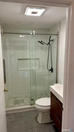 a bathroom with a toilet a sink and shower