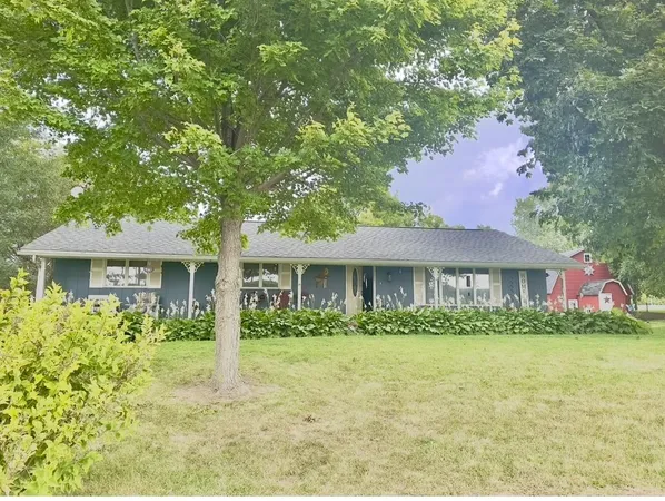 a front view of house with yard and green space
