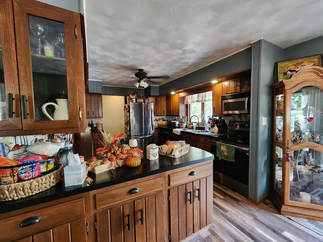 a kitchen area with stainless steel appliances a stove and a refrigerator