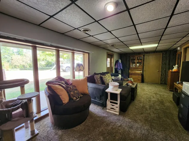 a living room with furniture gym equipment and a flat screen tv