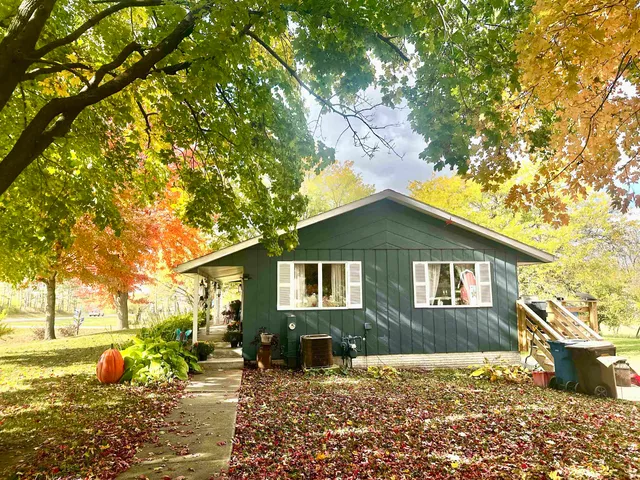 a front view of house with a garden