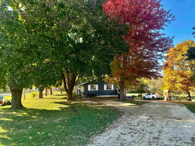 a front view of house with yard and green space