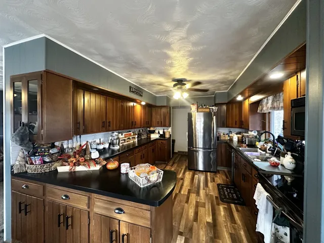 a room with lots of chairs and kitchen view