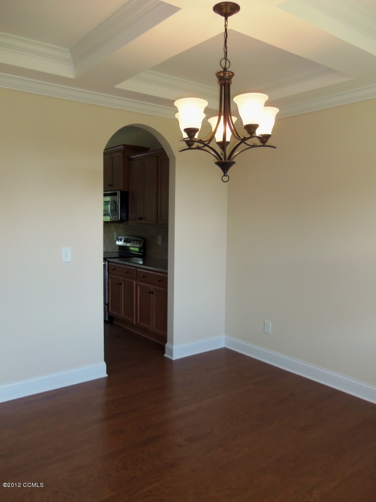 102 Summer Rst Trail Hubert, NC 28539 - Photo 4 of 9 Dining room features coffered ceiling and engineered hardwood flooring.