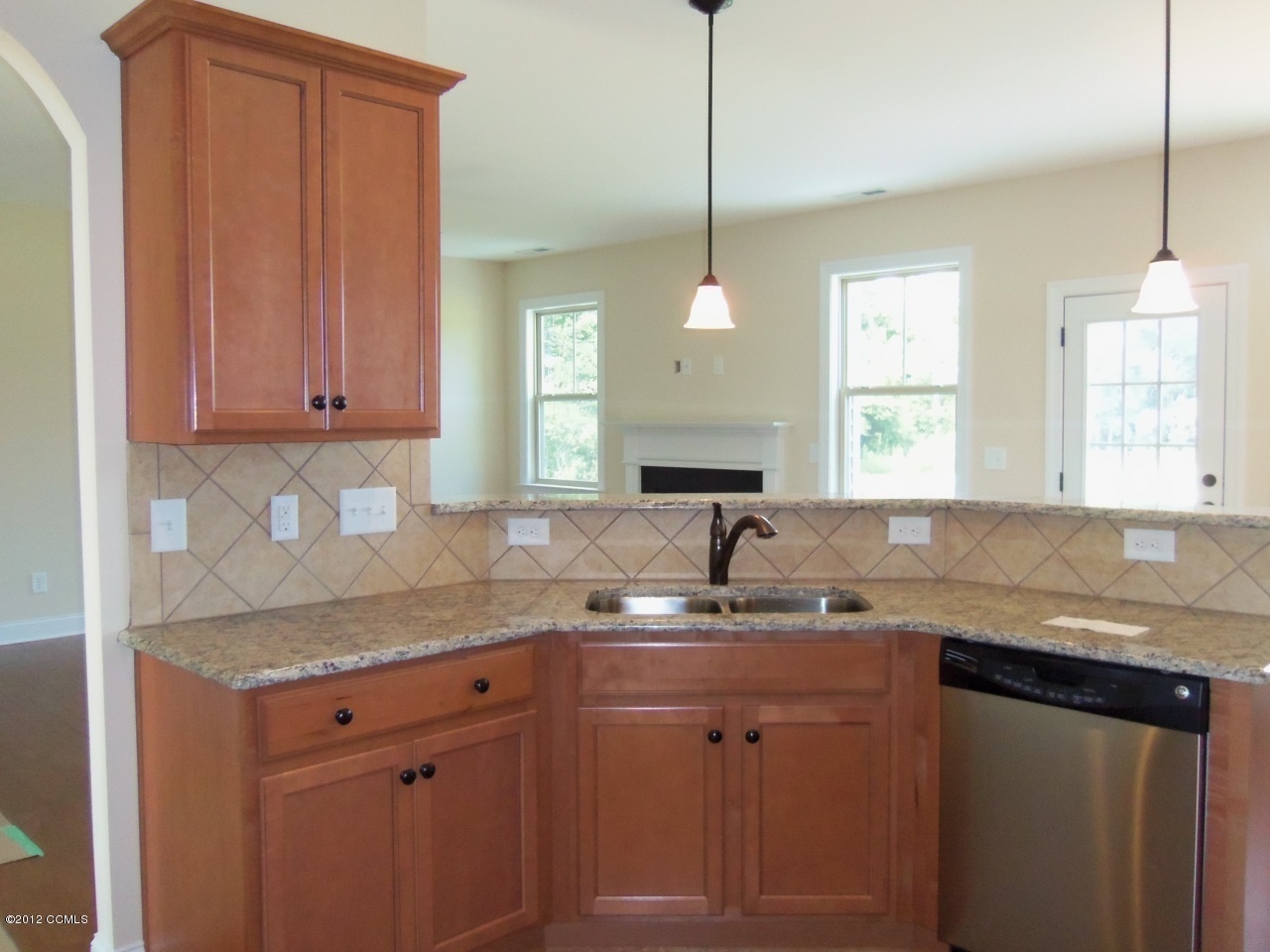 102 Summer Rst Trail Hubert, NC 28539 - Photo 5 of 9 Kithcen features engineered hardwood flooring, tile backsplash, stainless steel appliances, granite counters and breakfast bar.