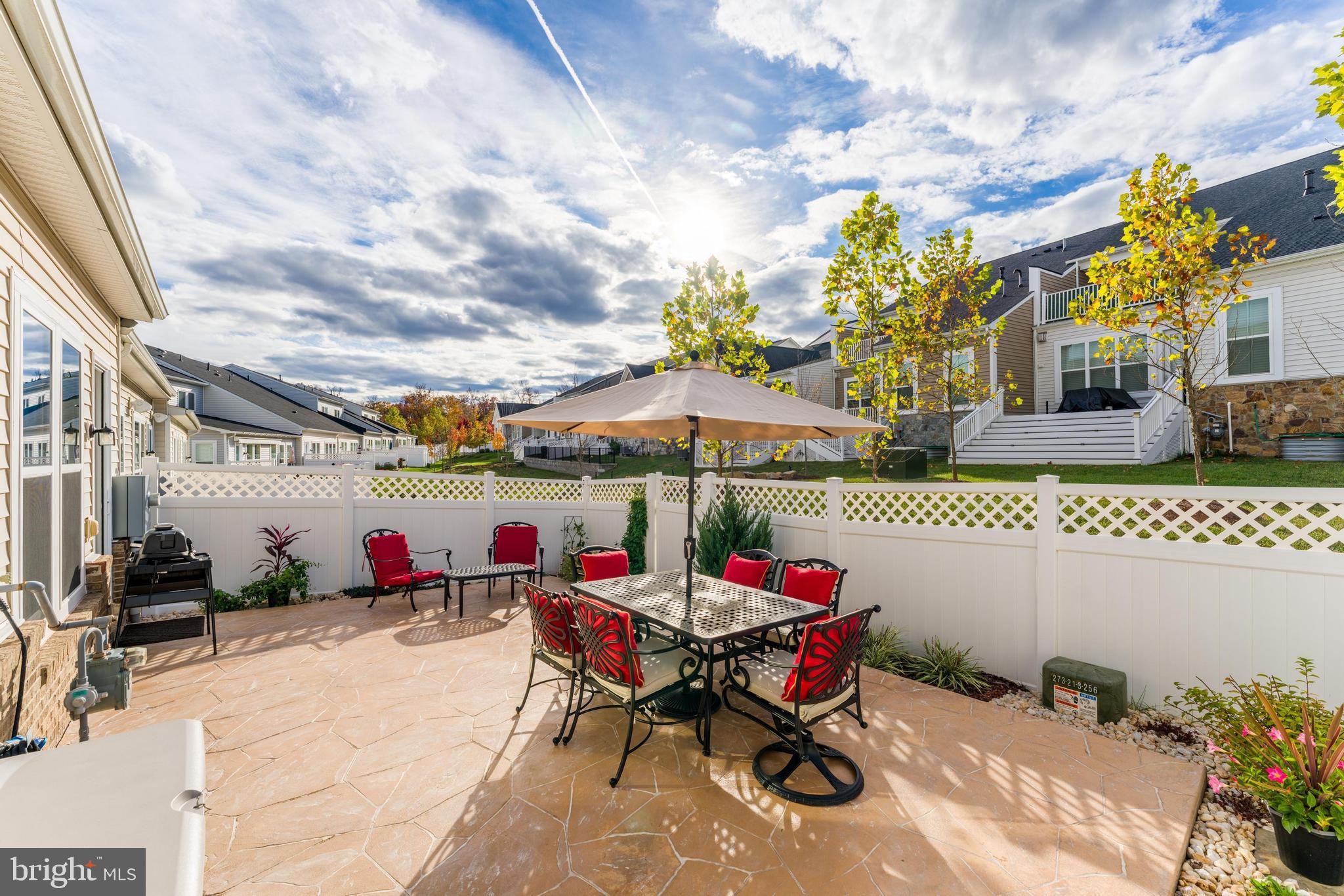 23707 Kinston Ferry Terrace Ashburn, VA 20148 - Photo 14 of 42 an outdoor space with furniture and umbrella