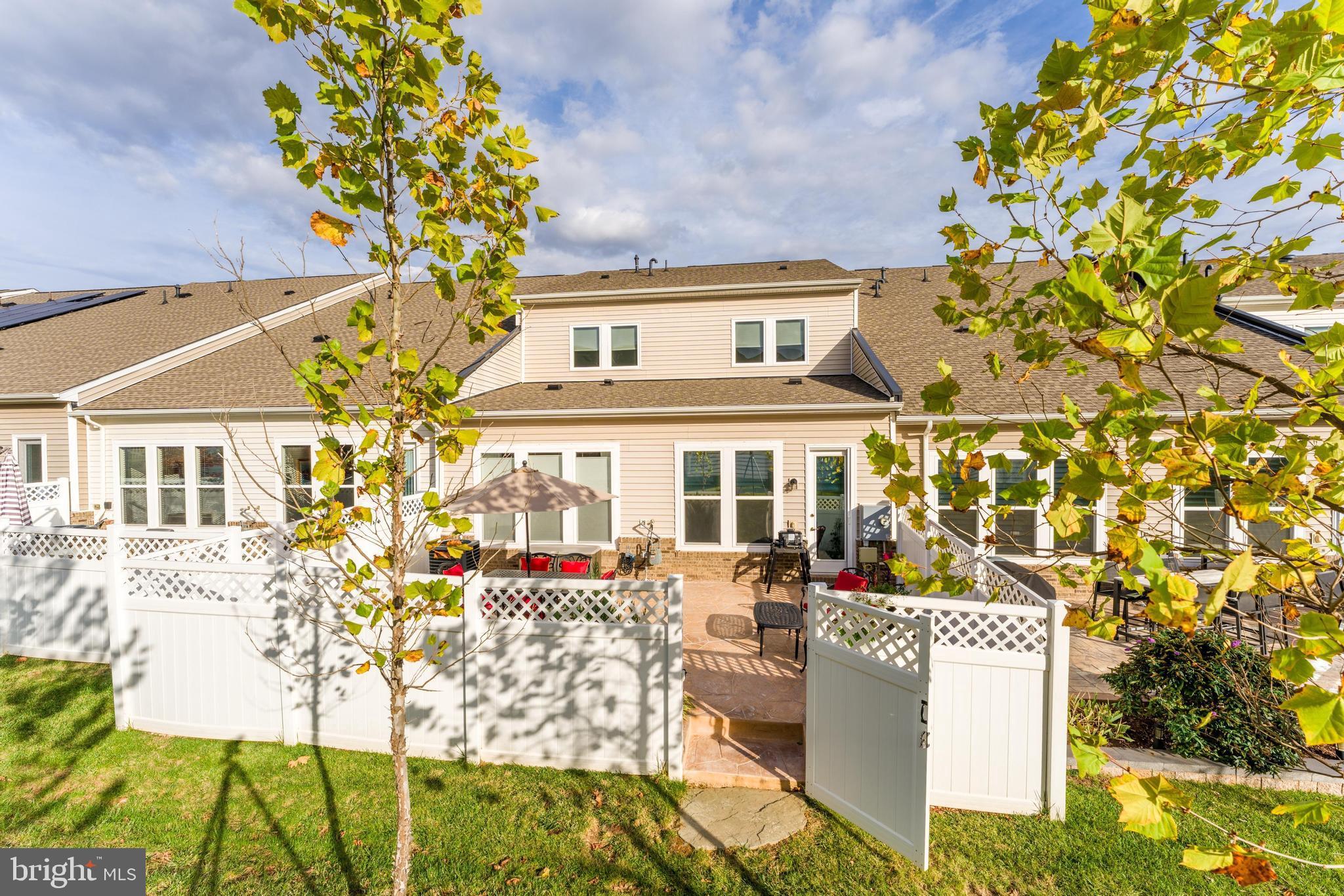 23707 Kinston Ferry Terrace Ashburn, VA 20148 - Photo 15 of 42 a front view of a house with a garden