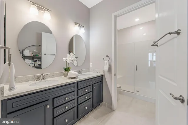 a bathroom with a double vanity sink and a mirror
