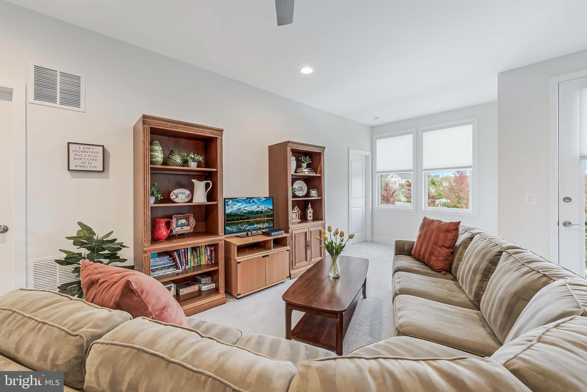 23707 Kinston Ferry Terrace Ashburn, VA 20148 - Photo 22 of 42 a living room with furniture and a book shelf