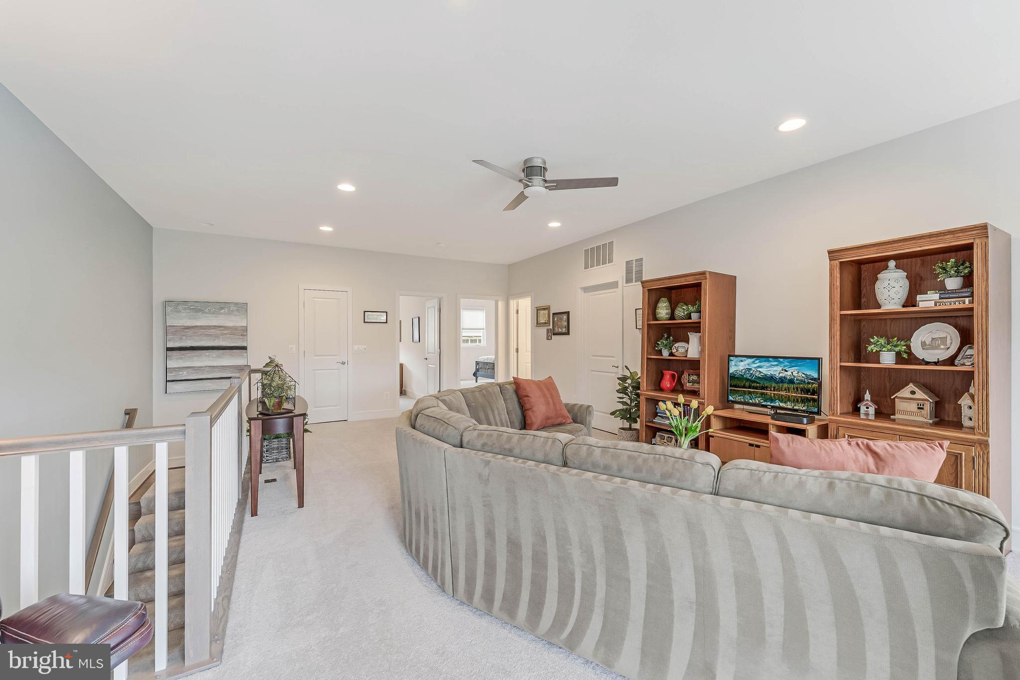 23707 Kinston Ferry Terrace Ashburn, VA 20148 - Photo 27 of 42 a living room with furniture and a flat screen tv