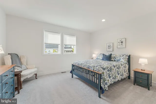 a bedroom with a bed chair and a window