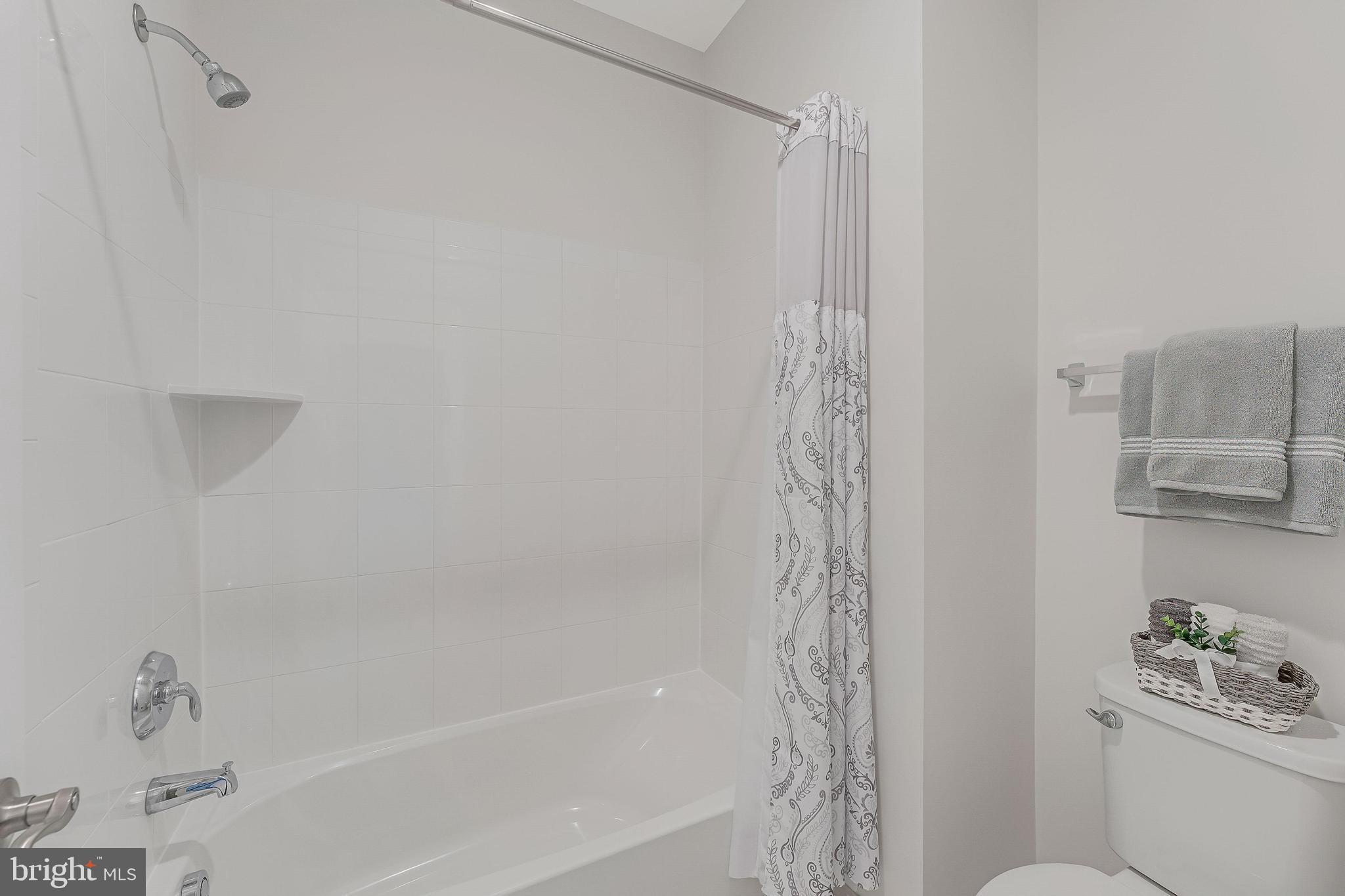 23707 Kinston Ferry Terrace Ashburn, VA 20148 - Photo 32 of 42 a bathroom with a shower curtain and a sink