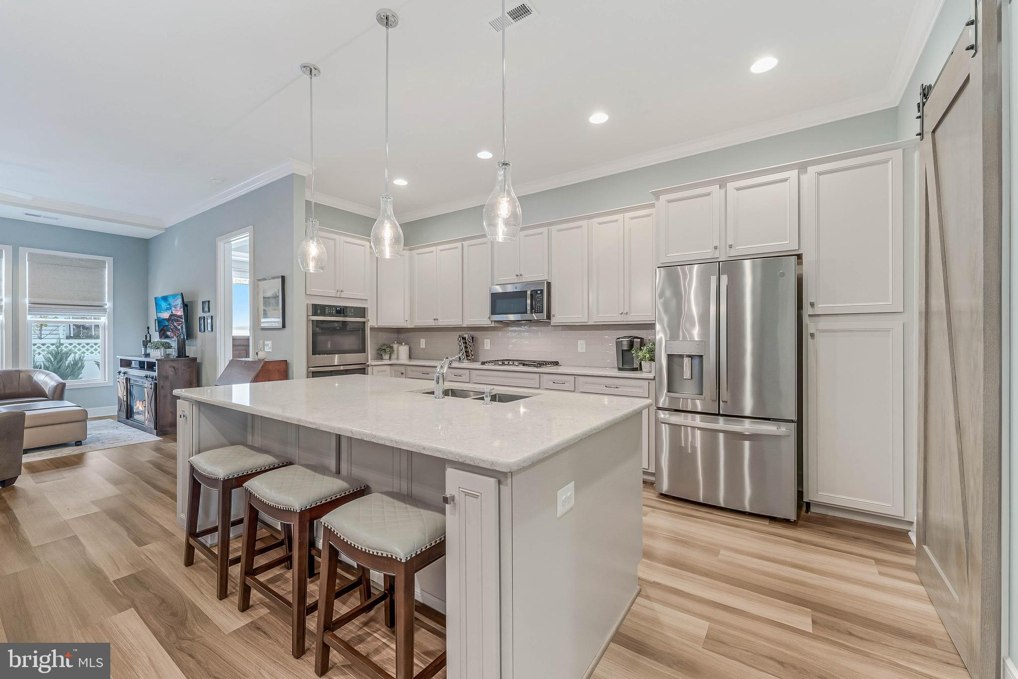 23707 Kinston Ferry Terrace Ashburn, VA 20148 - Photo 4 of 42 a kitchen with refrigerator and chairs