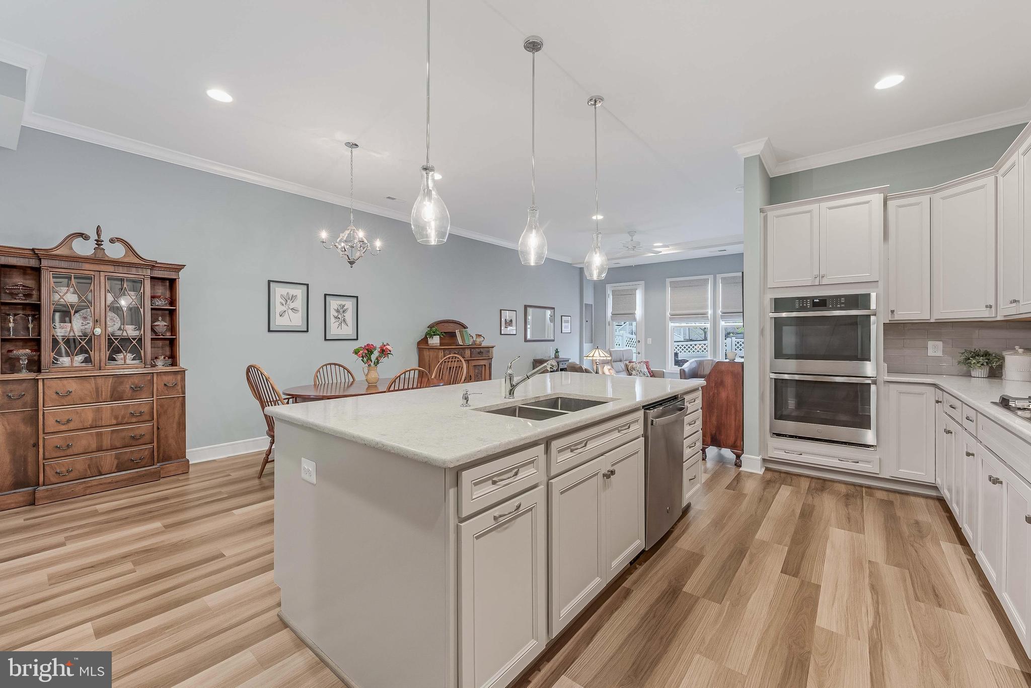 23707 Kinston Ferry Terrace Ashburn, VA 20148 - Photo 7 of 42 a large kitchen with stainless steel appliances kitchen island granite countertop a sink and cabinets