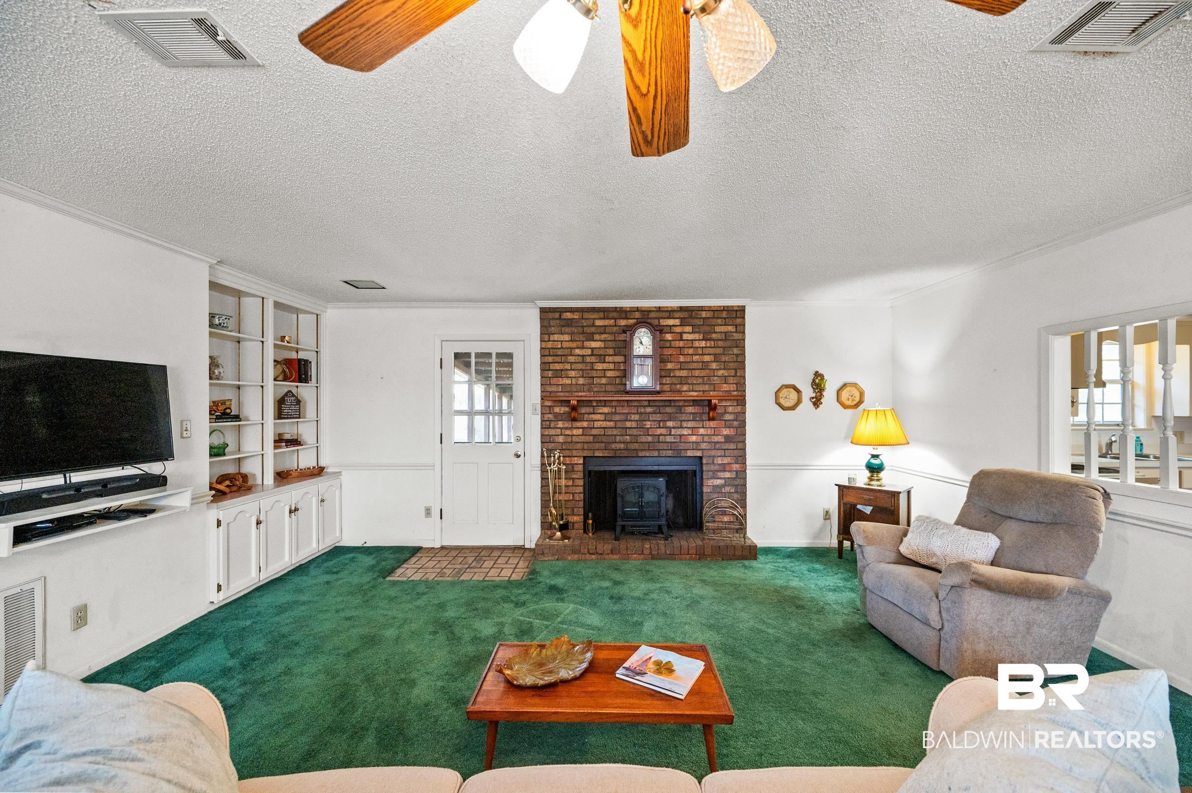 15600 Fackler Road Loxley, AL 36551 - Photo 46 of 51 Living room featuring carpet, a healthy amount of sunlight, and ceiling fan