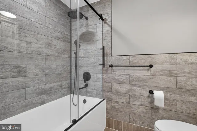 a bathroom with a bathtub and shower