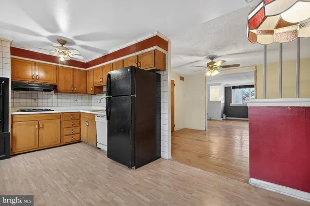 a kitchen with a refrigerator and a sink