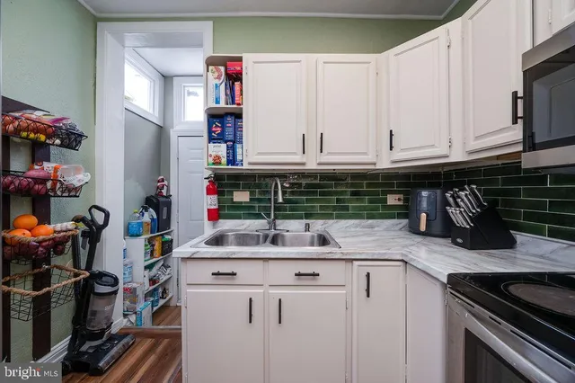a kitchen with a sink and cabinets