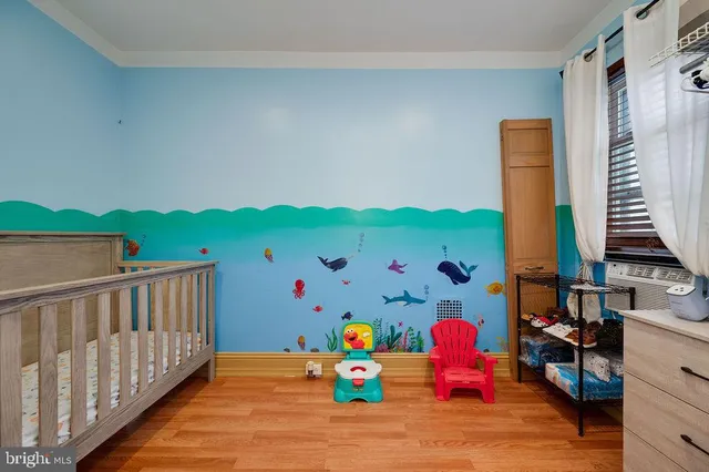 a view of a hallway with wooden floor and stairs