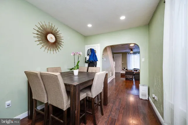 a dining room with furniture and wooden floor