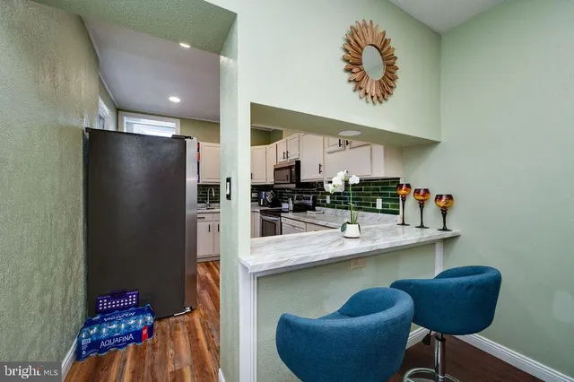 a kitchen with stainless steel appliances granite countertop a refrigerator and a sink