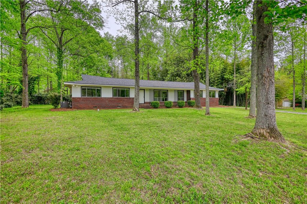 555 Joy Street Jackson, GA 30233 - Photo 1 of 56 a house view with a garden space