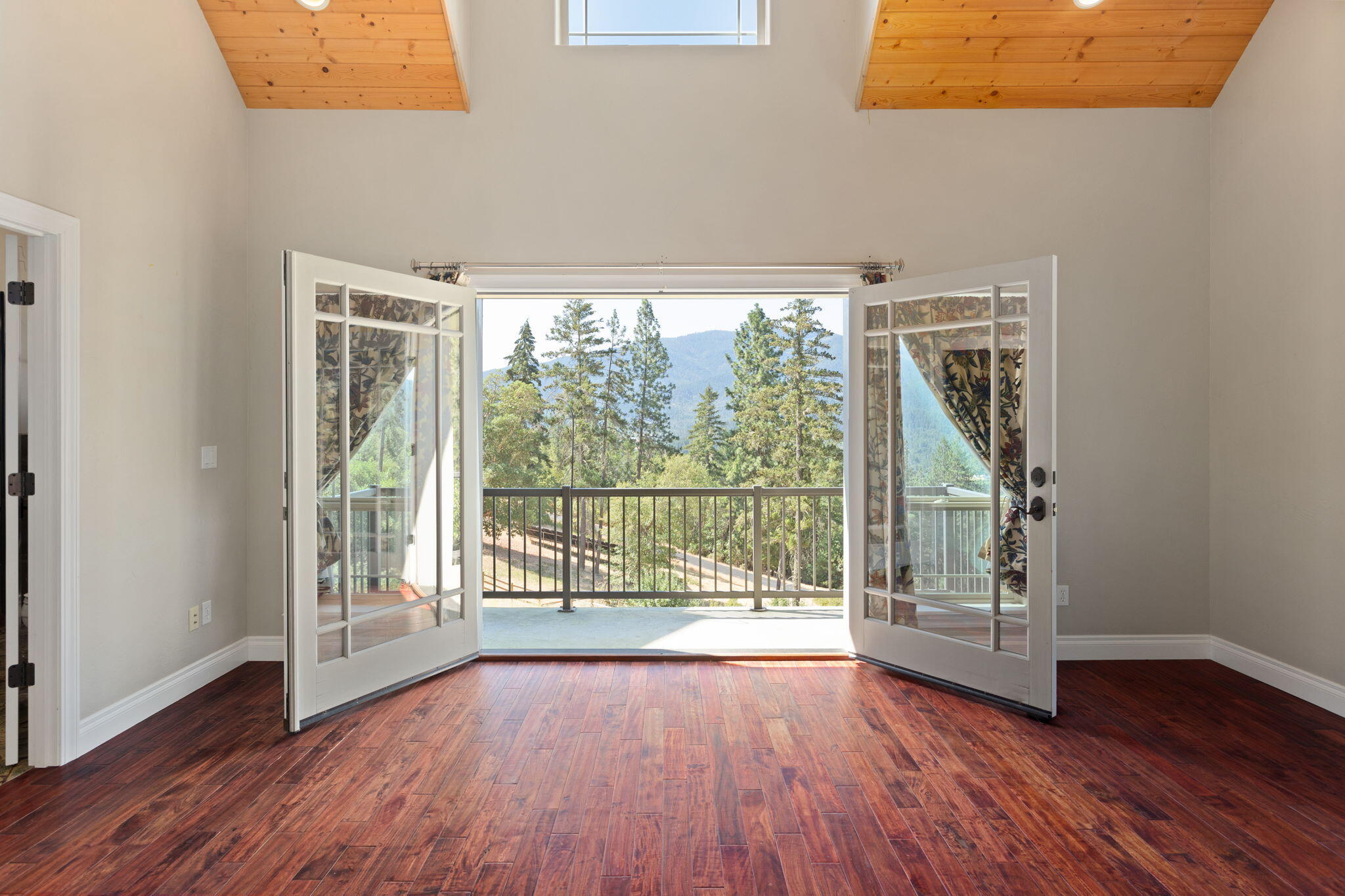 7304 North Applegate Road Grants Pass, OR 97527 - Photo 33 of 87 a view of an empty room with wooden floor and a window