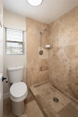 a bathroom with a granite countertop sink a mirror and a shower