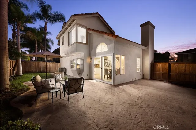 a view of a patio with a table and chairs