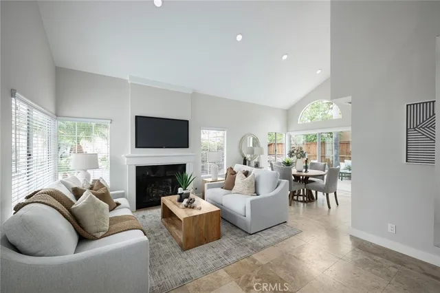 a living room with furniture a fireplace and a flat screen tv