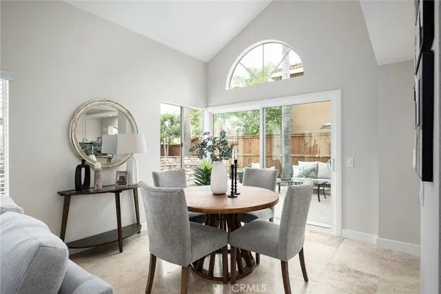 a view of a dining room with furniture a chandelier and wooden floor