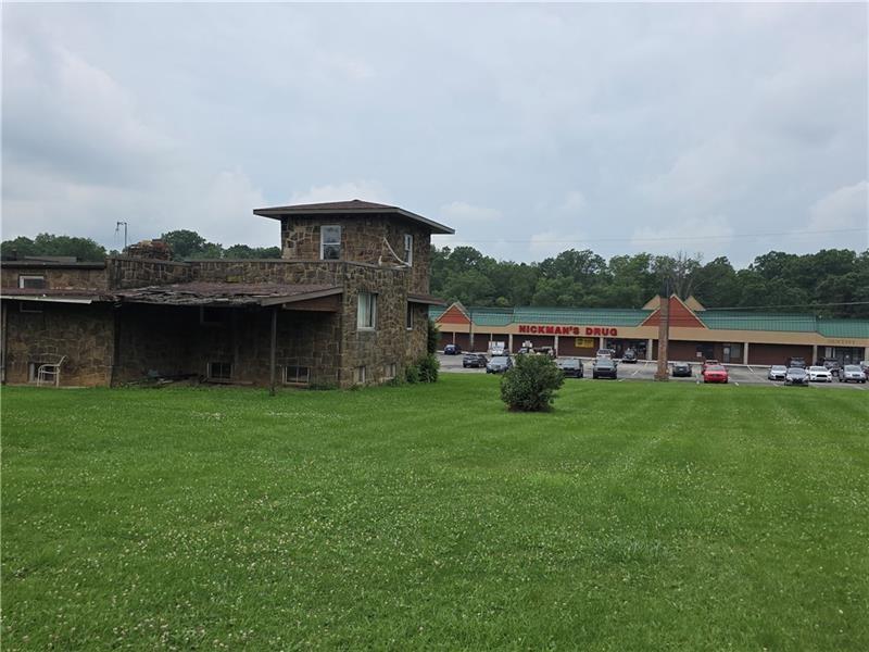 1356 Connellsville Road Lemont Furnace, PA 15456 - Photo 14 of 15 a view of a house with a big yard and a large tree