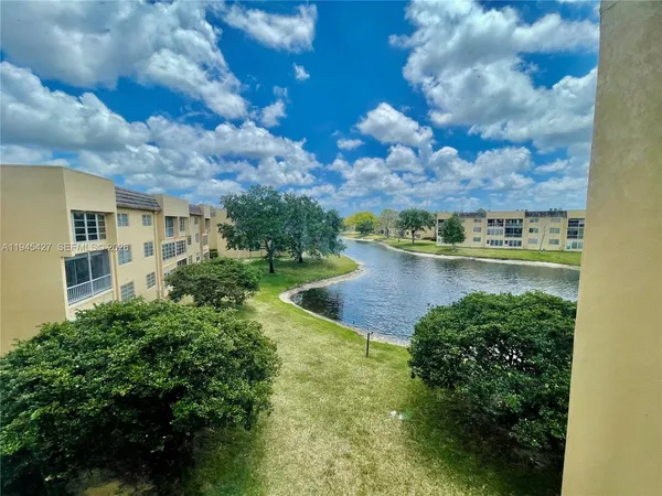 a view of a lake with houses in back