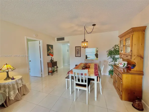 a dining room with furniture and a chandelier