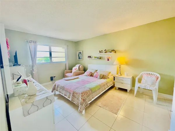 a bedroom with a bed and a chair