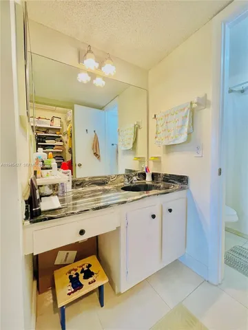 a bathroom with a sink mirror and vanity