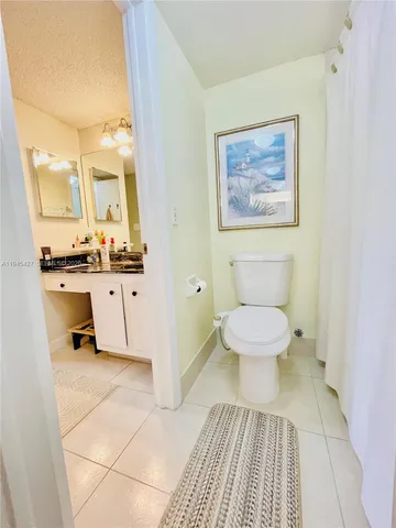 a spacious bathroom with a toilet sink and mirror
