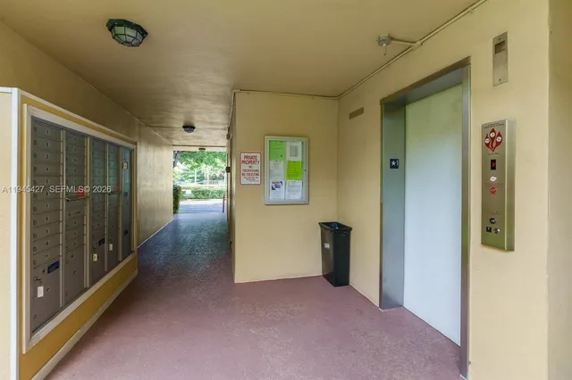 a view of a hallway with wooden shelves