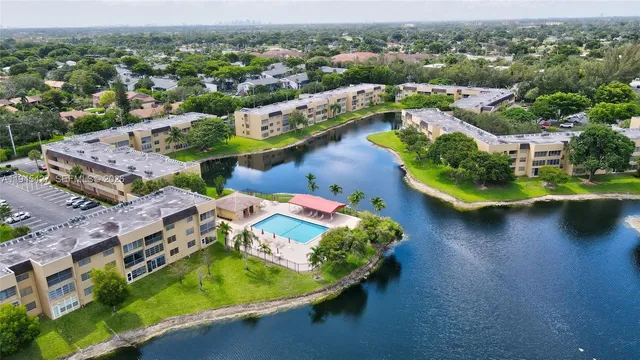 an aerial view of residential houses with outdoor space and river