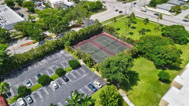 an aerial view of a house with garden space and a street view