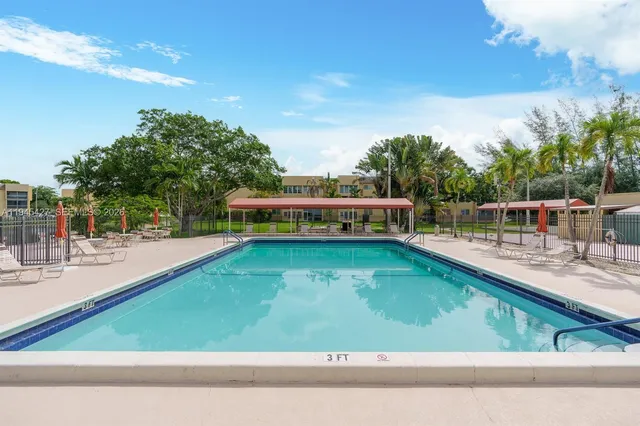 a view of a swimming pool with a patio