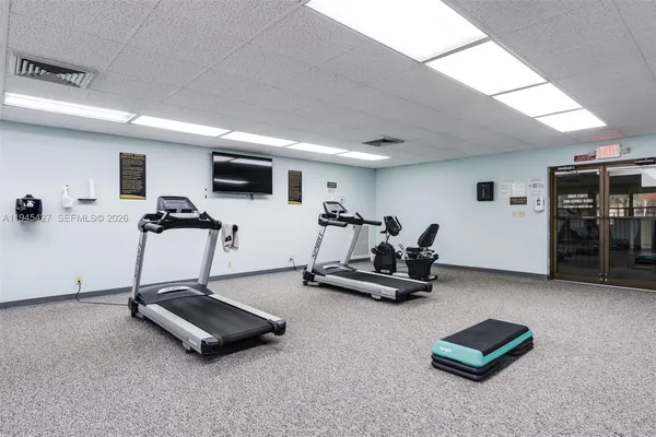 a room with gym equipment and a table