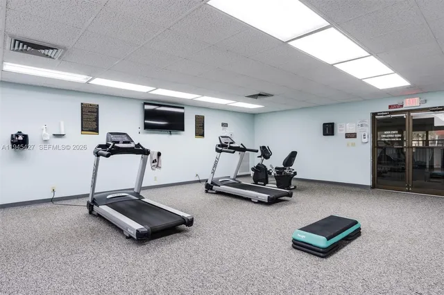 a room with gym equipment and a table