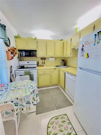 a kitchen with a sink appliances and cabinets