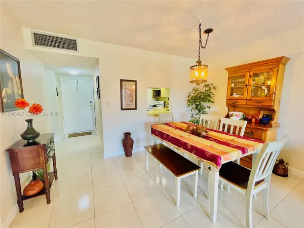a dining room with a table and chairs