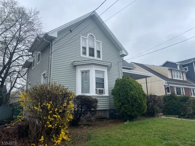 a view of a house with a yard and plants