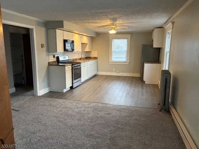 a kitchen with stainless steel appliances a stove top oven a sink and a microwave