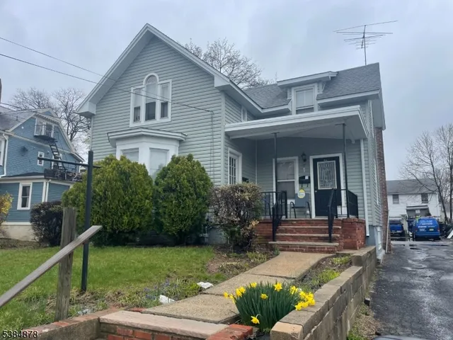 a view of house with backyard and garden