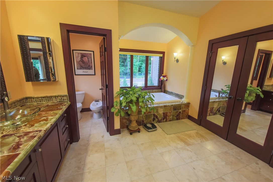 6290 Riverview Road Peninsula, OH 44264 - Photo 18 of 35 Double doors to the large walk-in closet, jetted tub, double sink & private water closet w/ bidet.